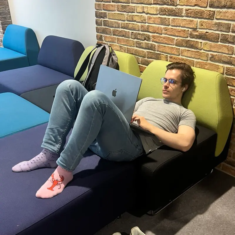 Working on a laptop on the couch at university